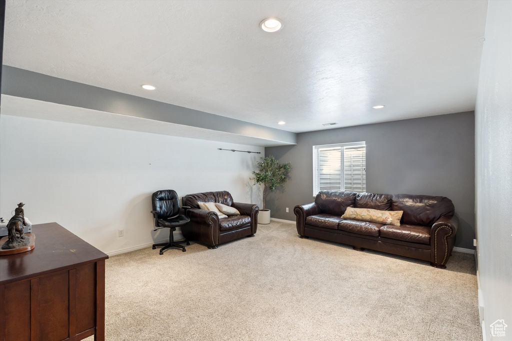 Carpeted living room featuring recessed lighting and baseboards