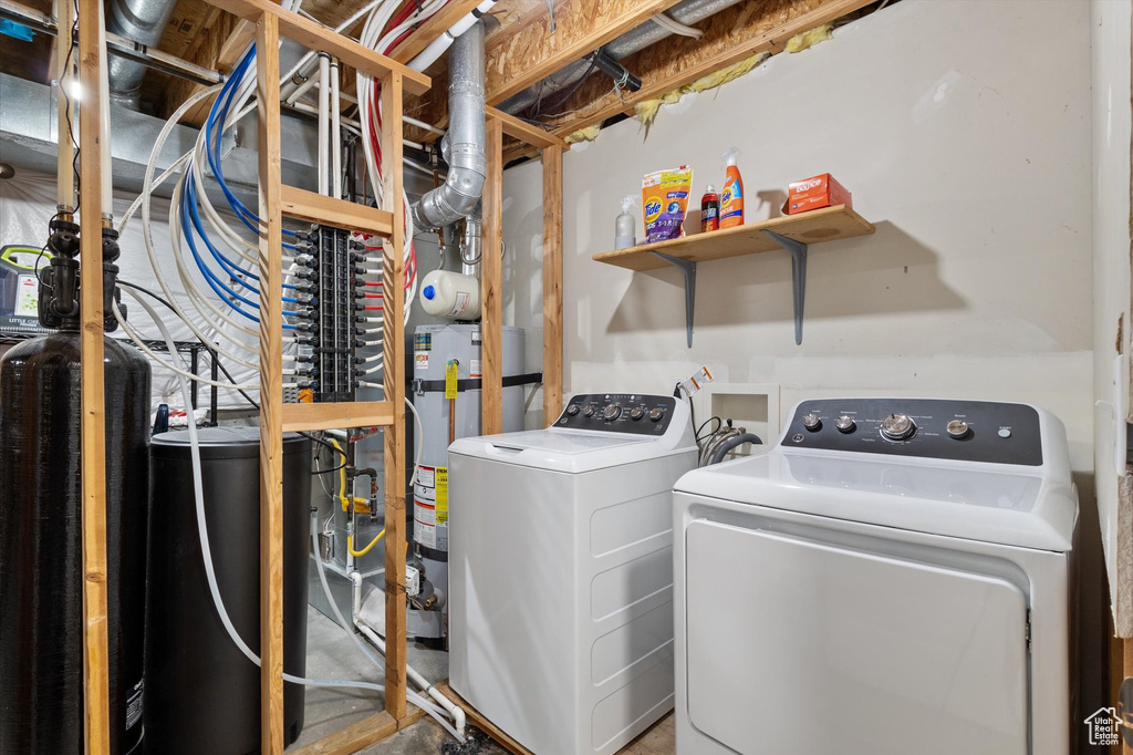 Washroom with gas water heater, laundry area, and washing machine and clothes dryer