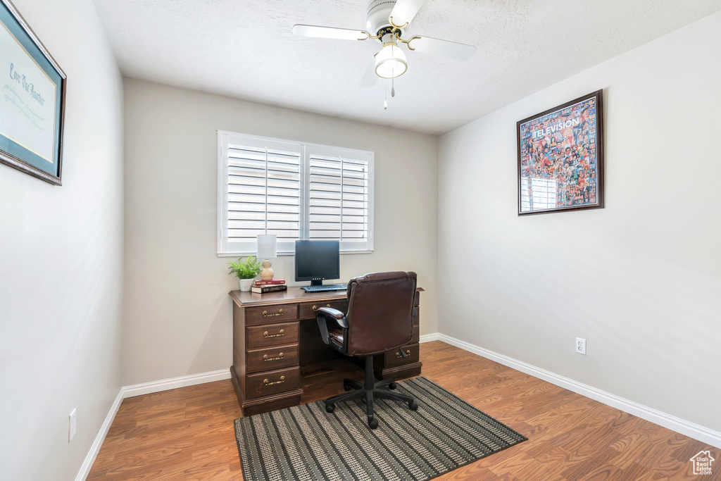 Office featuring wood finished floors, baseboards, and ceiling fan