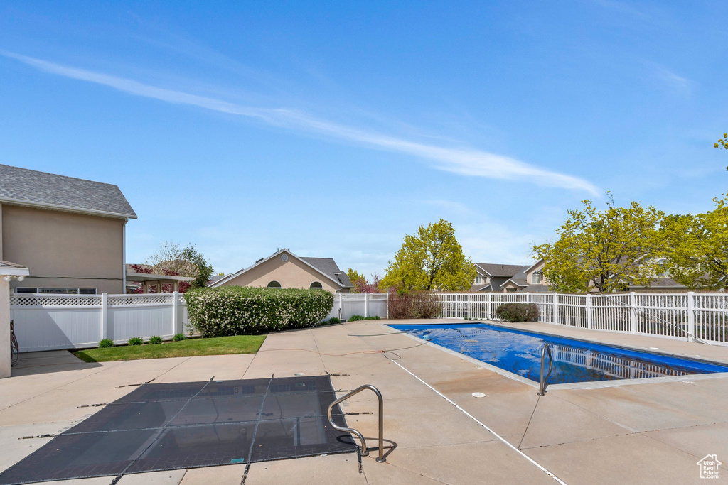 View of pool with a fenced backyard, a patio, and a fenced in pool