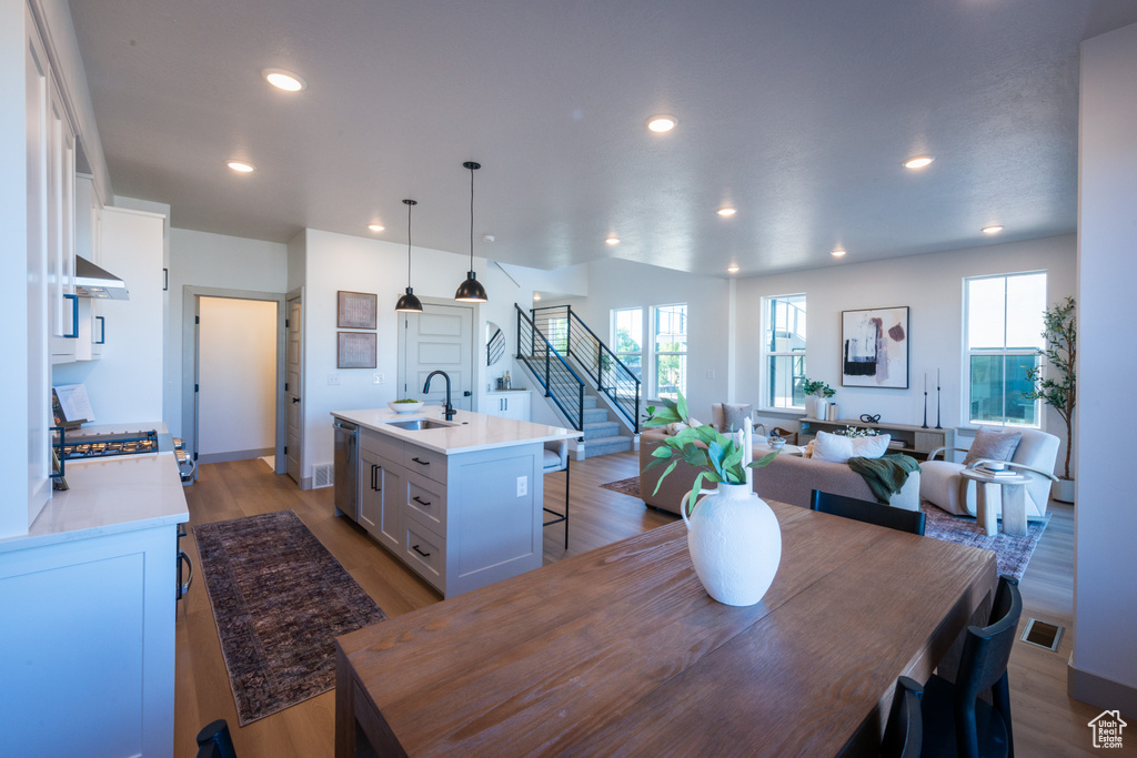 Dining room with recessed lighting, a wealth of natural light, stairway, and visible vents