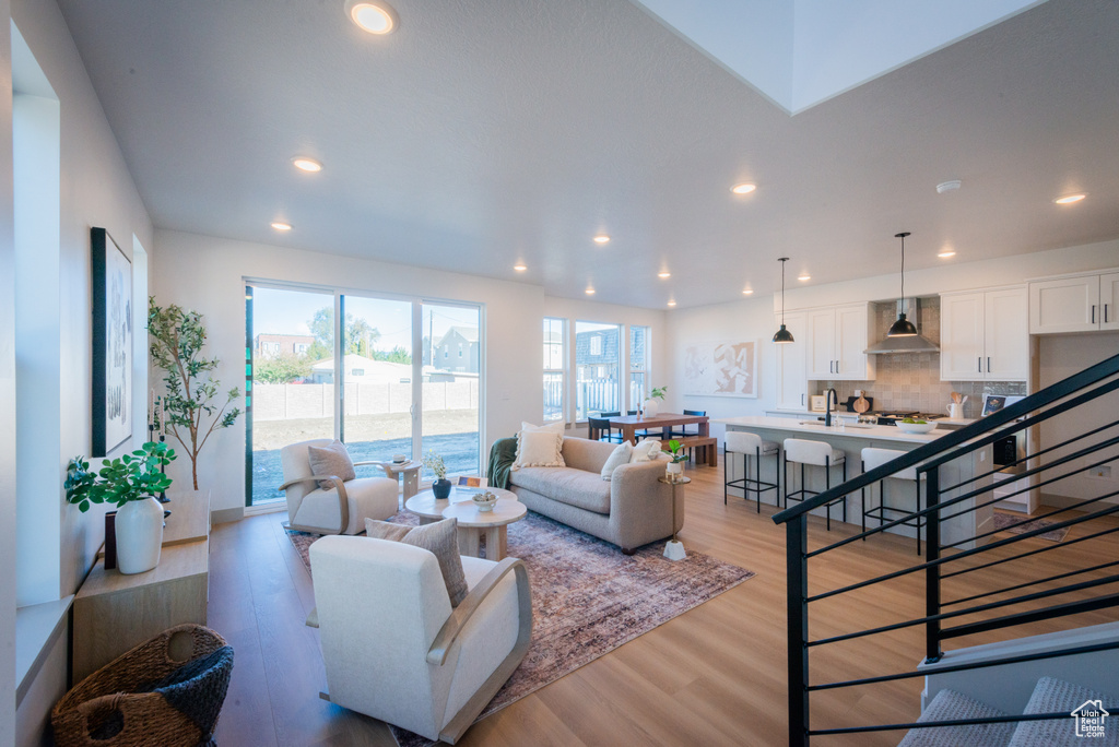 Living room with recessed lighting and light wood finished floors