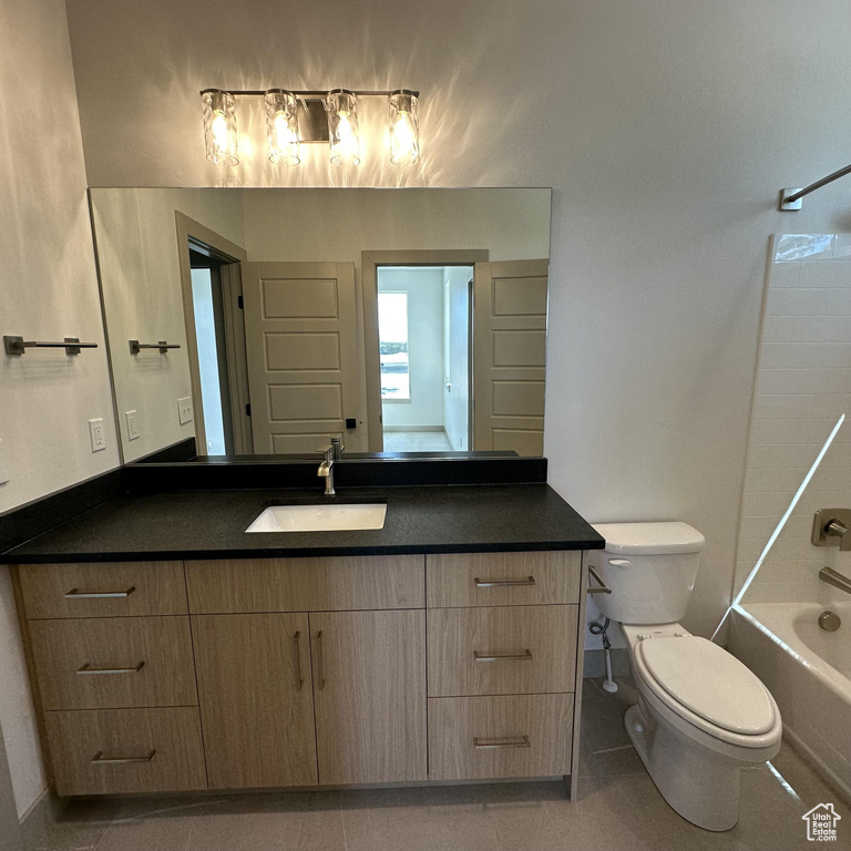 Bathroom with vanity, bathing tub / shower combination, toilet, baseboards, and tile patterned floors