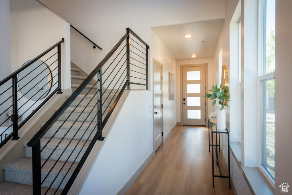 Interior space with recessed lighting, stairs, and wood finished floors