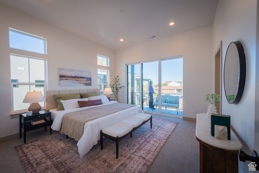 Carpeted bedroom featuring visible vents, recessed lighting, baseboards, and access to exterior