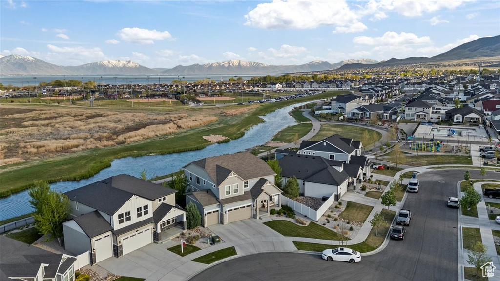 Drone / aerial view with a water and mountain view and a residential view