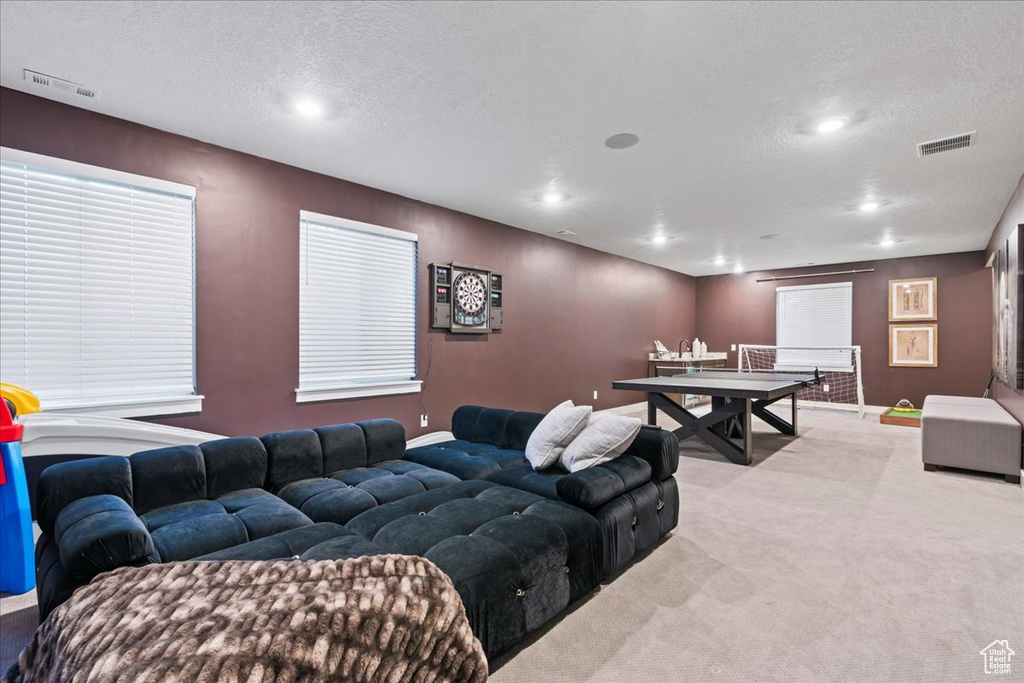 Carpeted living room featuring visible vents, recessed lighting, a textured ceiling, and baseboards