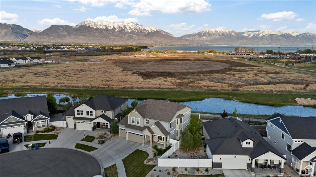 Drone / aerial view featuring a water and mountain view and a residential view