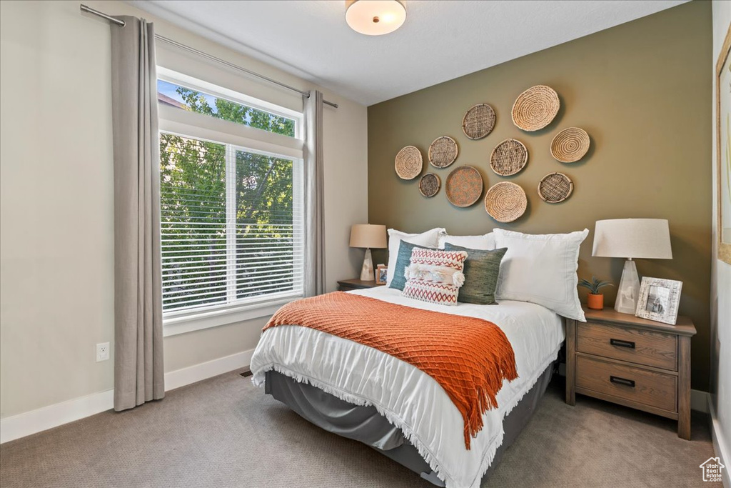 Bedroom featuring carpet floors and baseboards