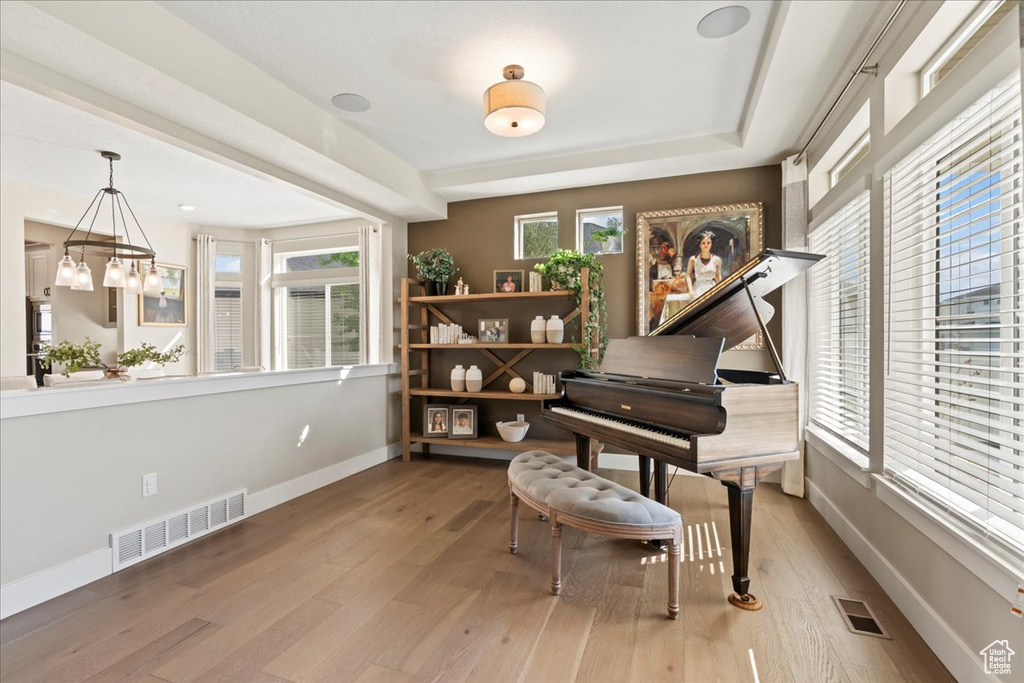 Sitting room featuring baseboards, visible vents, and wood finished floors