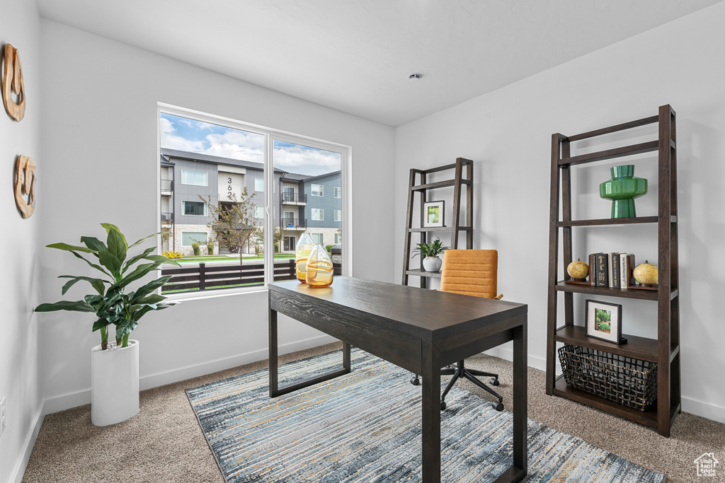 Carpeted office space featuring baseboards