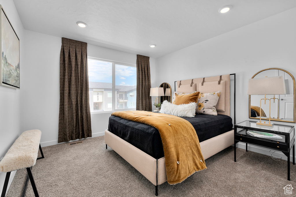 Carpeted bedroom featuring baseboards, recessed lighting, and visible vents