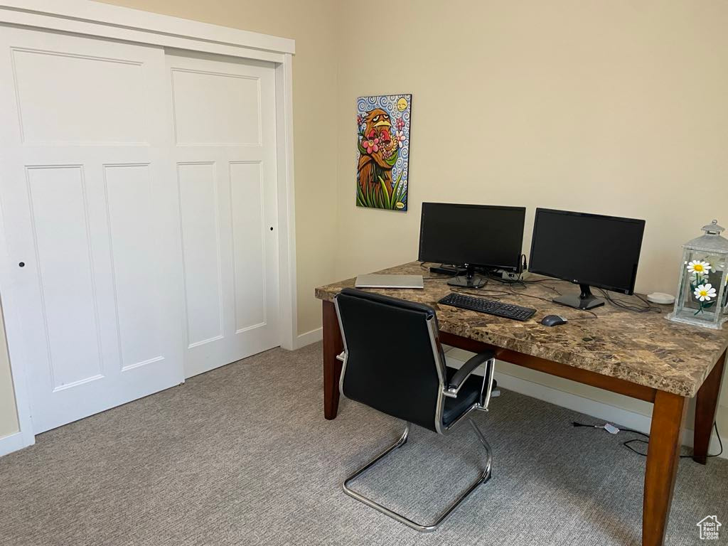 Office area featuring carpet floors and baseboards
