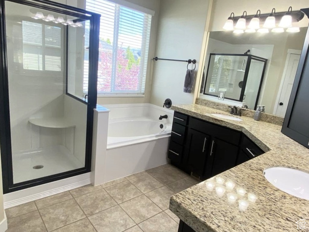 Full bath with vanity, a stall shower, tile patterned floors, and a bath