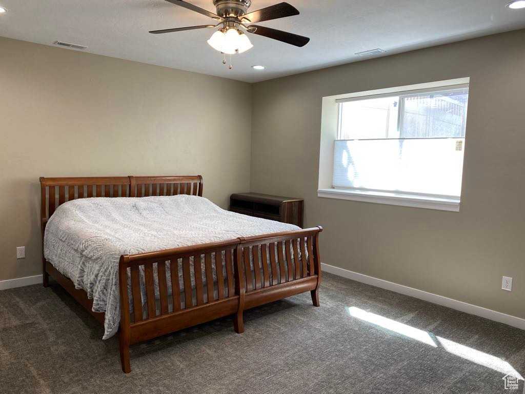 Carpeted bedroom with visible vents, recessed lighting, and baseboards