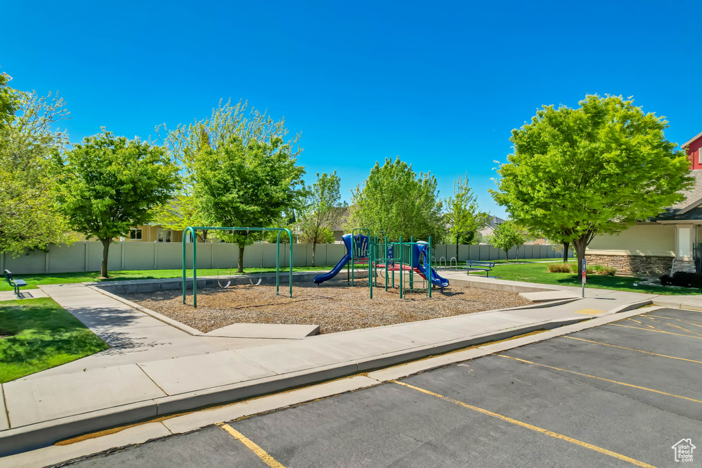 Community playground with a lawn and fence