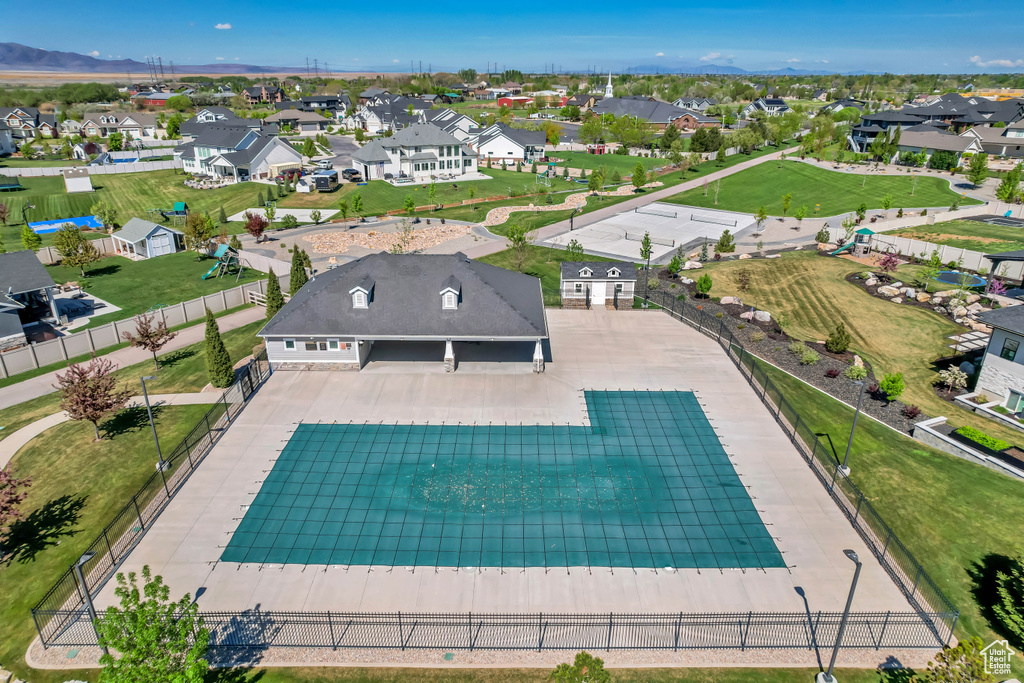 View of swimming pool with a mountain view, fence, and a residential view