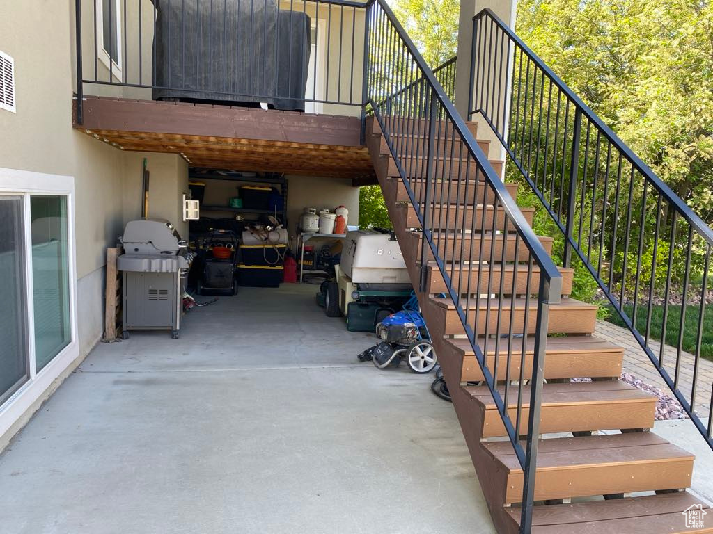 View of patio with stairway and grilling area