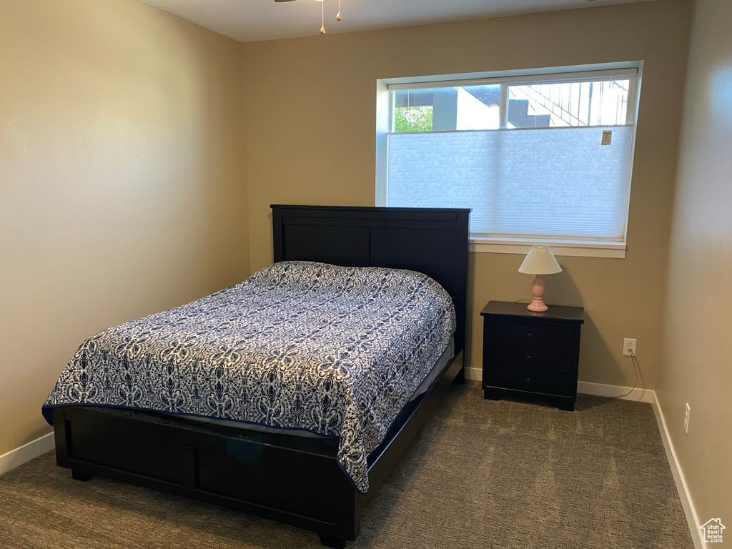 Bedroom with baseboards and carpet