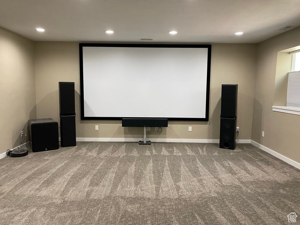 Carpeted cinema room with recessed lighting and baseboards