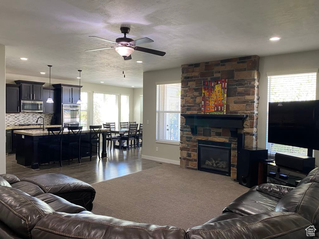 Living room with baseboards, recessed lighting, ceiling fan, and wood finished floors