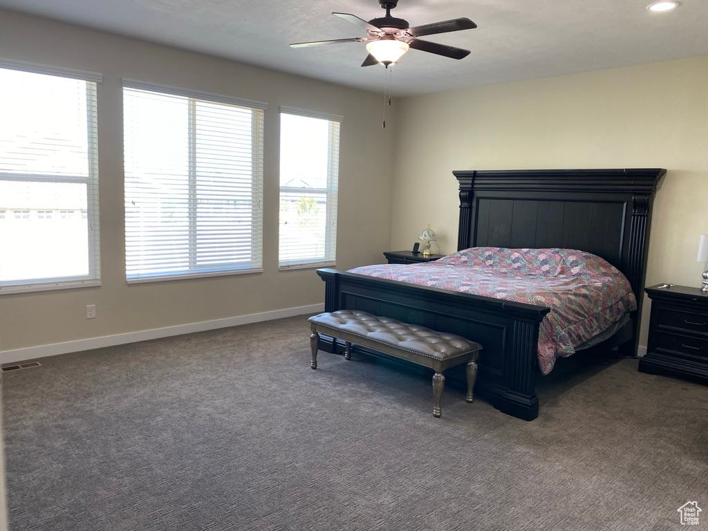 Carpeted bedroom with a ceiling fan, baseboards, visible vents, and recessed lighting