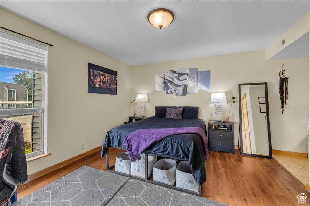 Bedroom featuring baseboards and wood finished floors