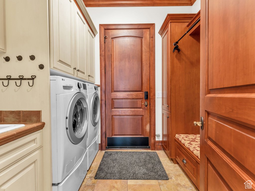 Washroom with cabinet space and washing machine and dryer