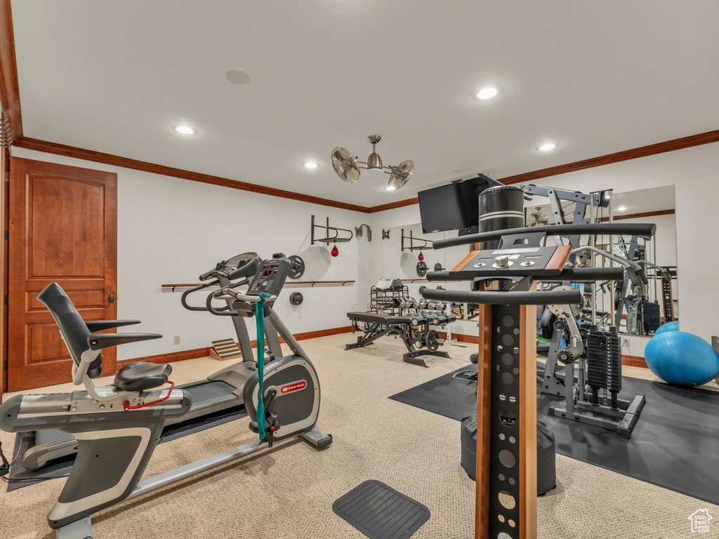Gym featuring recessed lighting, ornamental molding, and baseboards