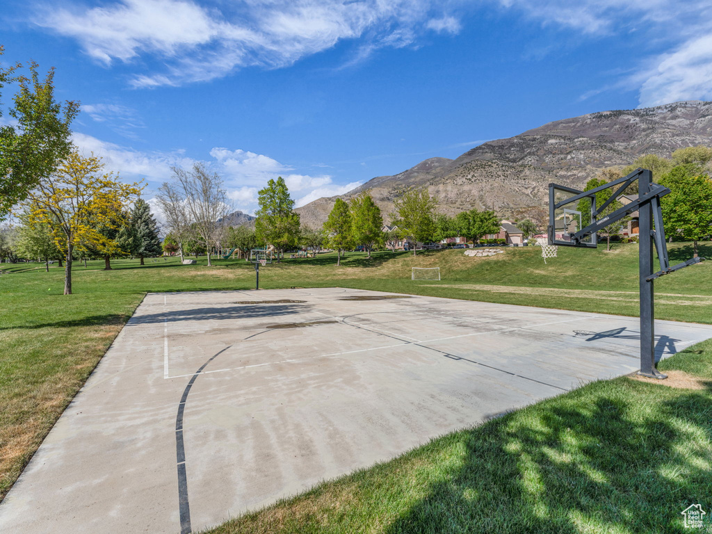 View of basketball court with a lawn, community basketball court, and a mountain view