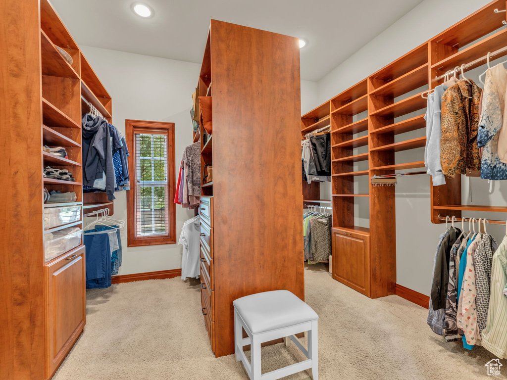 Spacious closet with light carpet