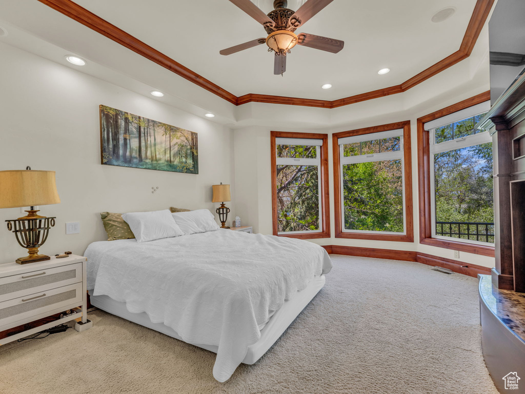 Carpeted bedroom featuring ornamental molding, a ceiling fan, multiple windows, and recessed lighting