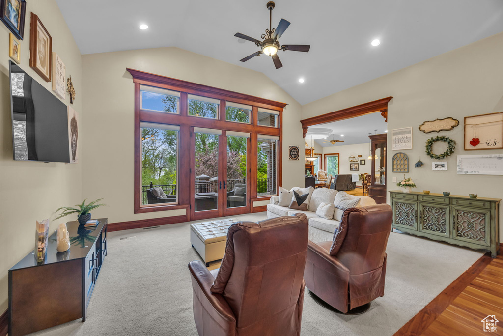 Living area with light wood-style floors, french doors, a ceiling fan, recessed lighting, and lofted ceiling