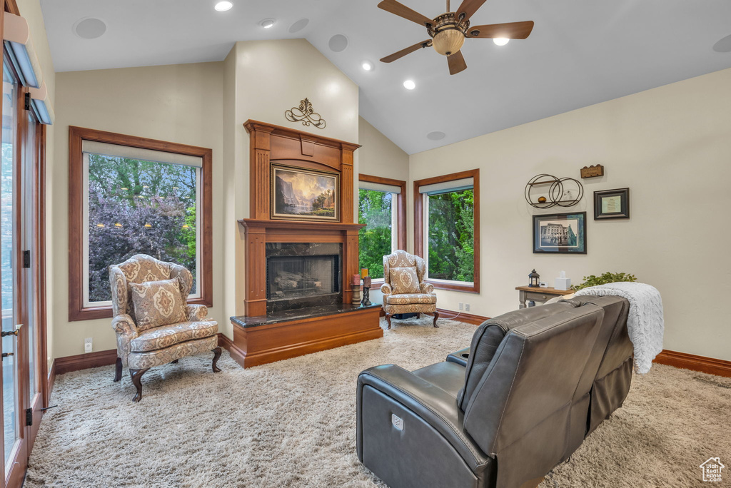 Carpeted living room with baseboards, high vaulted ceiling, recessed lighting, a ceiling fan, and a premium fireplace