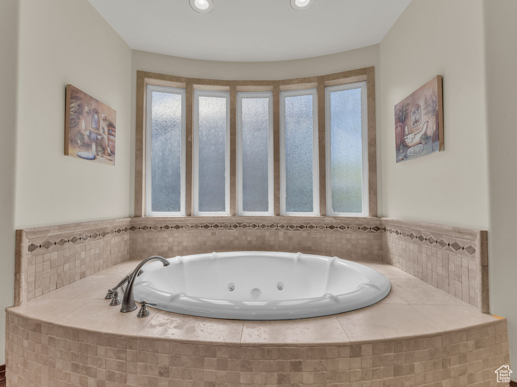 Full bathroom featuring recessed lighting and a tub with jets