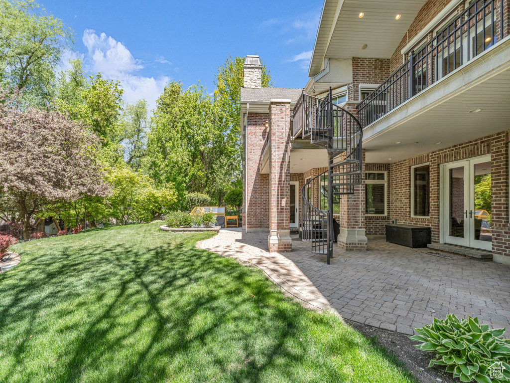 View of yard with a patio, french doors, and stairs