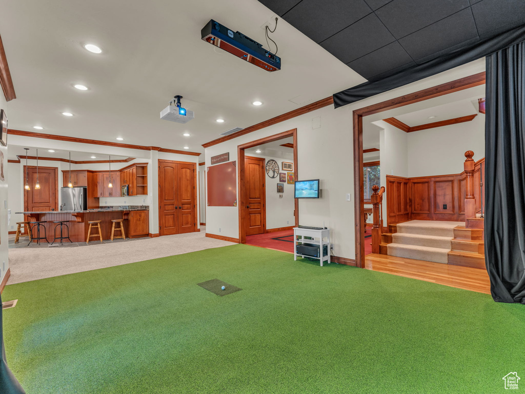 Interior space with light carpet, stairs, recessed lighting, baseboards, and ornamental molding