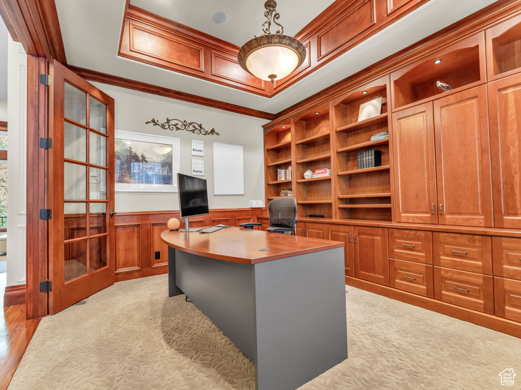 Office area with crown molding, a wainscoted wall, a decorative wall, and light colored carpet