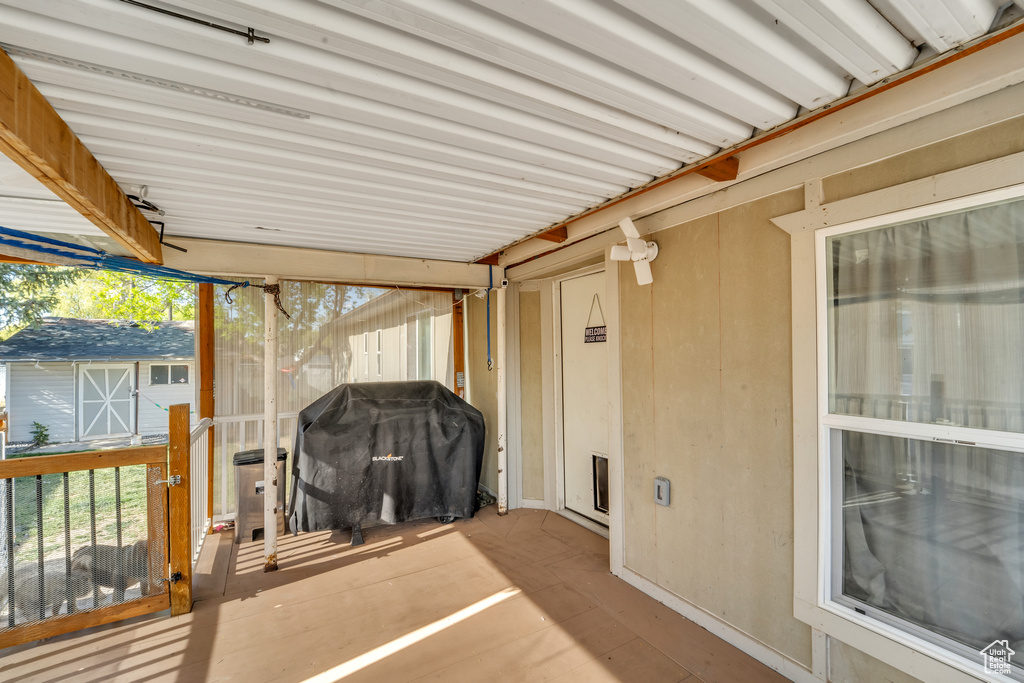 Exterior space with an outbuilding, area for grilling, and a deck
