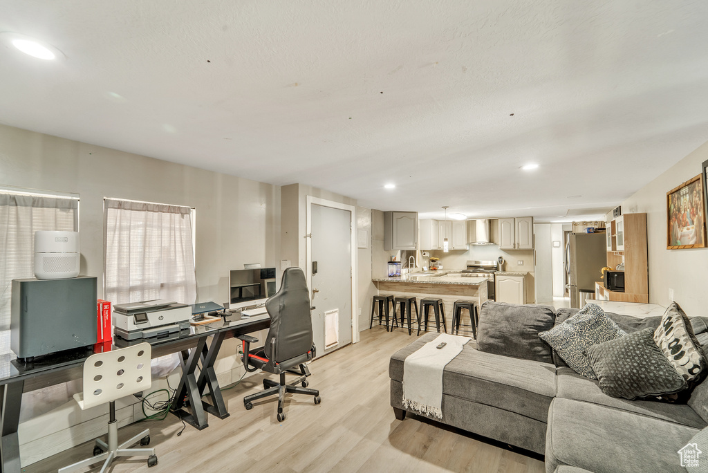 Office space featuring recessed lighting, a sink, light wood-style flooring, and visible vents
