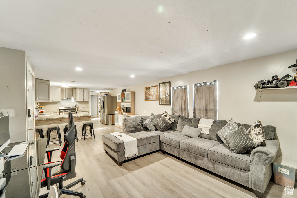 Living area featuring recessed lighting and light wood-style floors