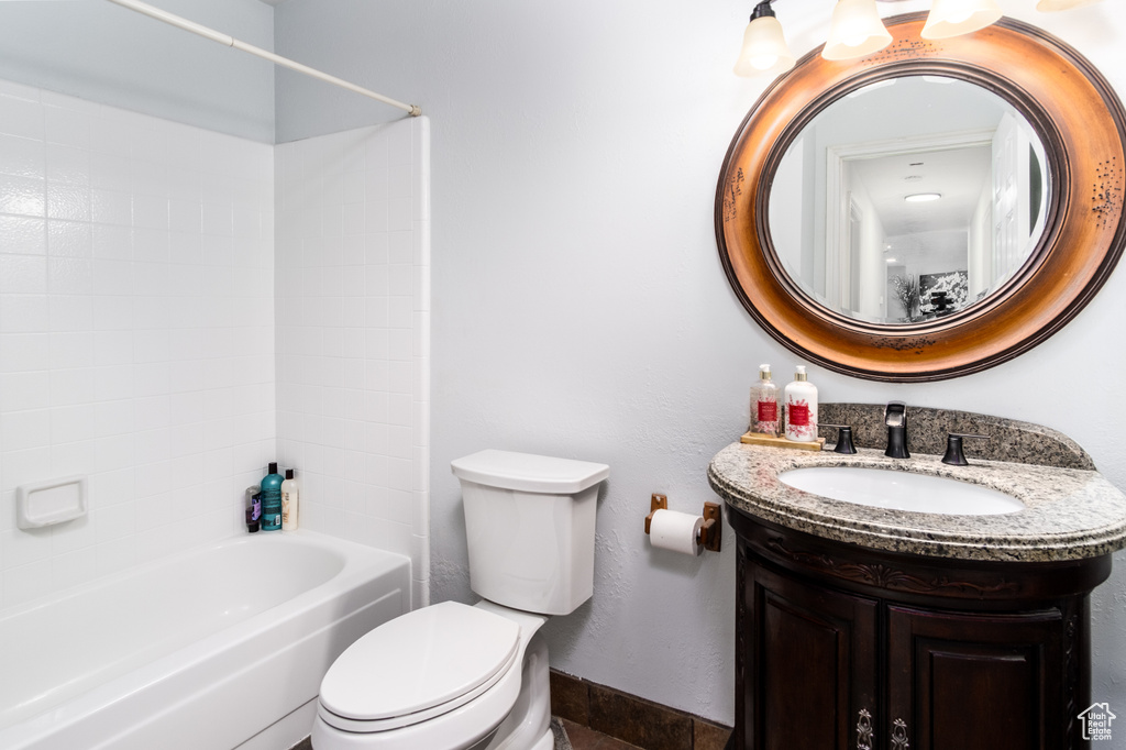 Full bathroom featuring vanity, baseboards, shower / bathtub combination, and toilet