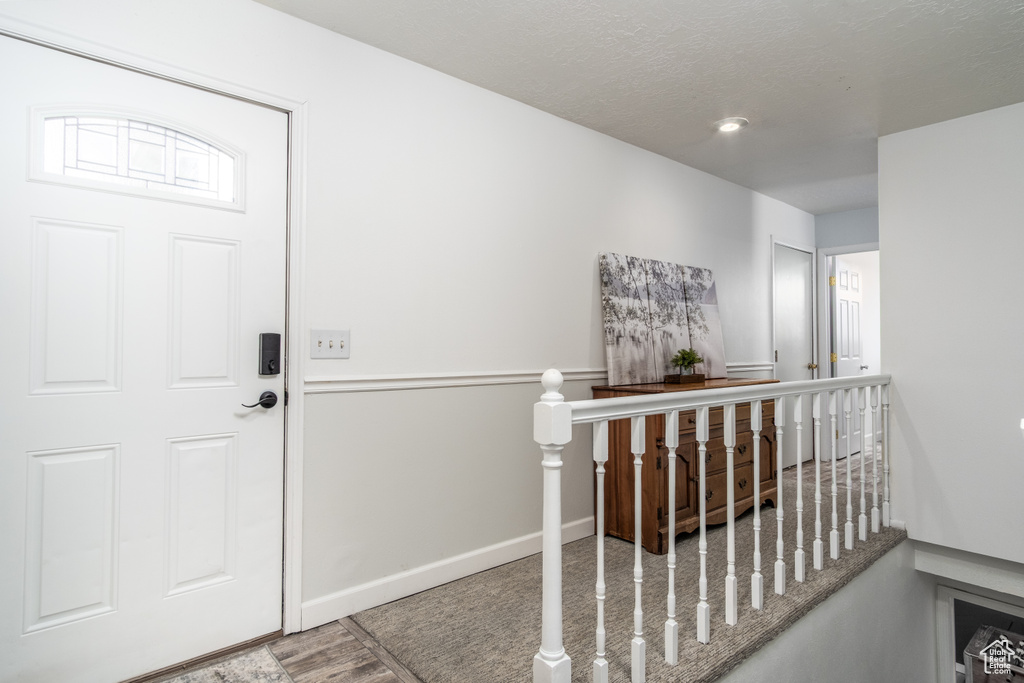 Foyer entrance with baseboards and wood finished floors