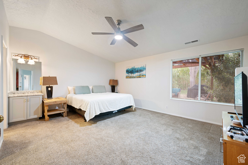 Bedroom with ceiling fan, light carpet, baseboards, lofted ceiling, and visible vents