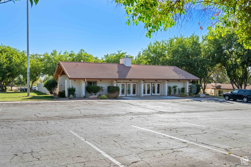 View of property featuring uncovered parking