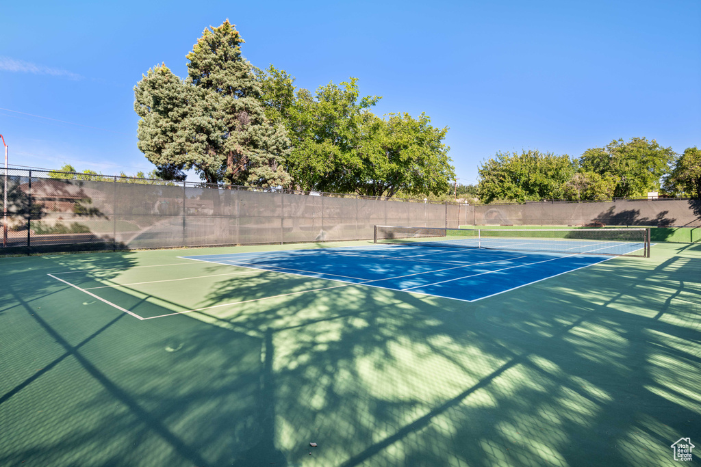 View of tennis court featuring fence