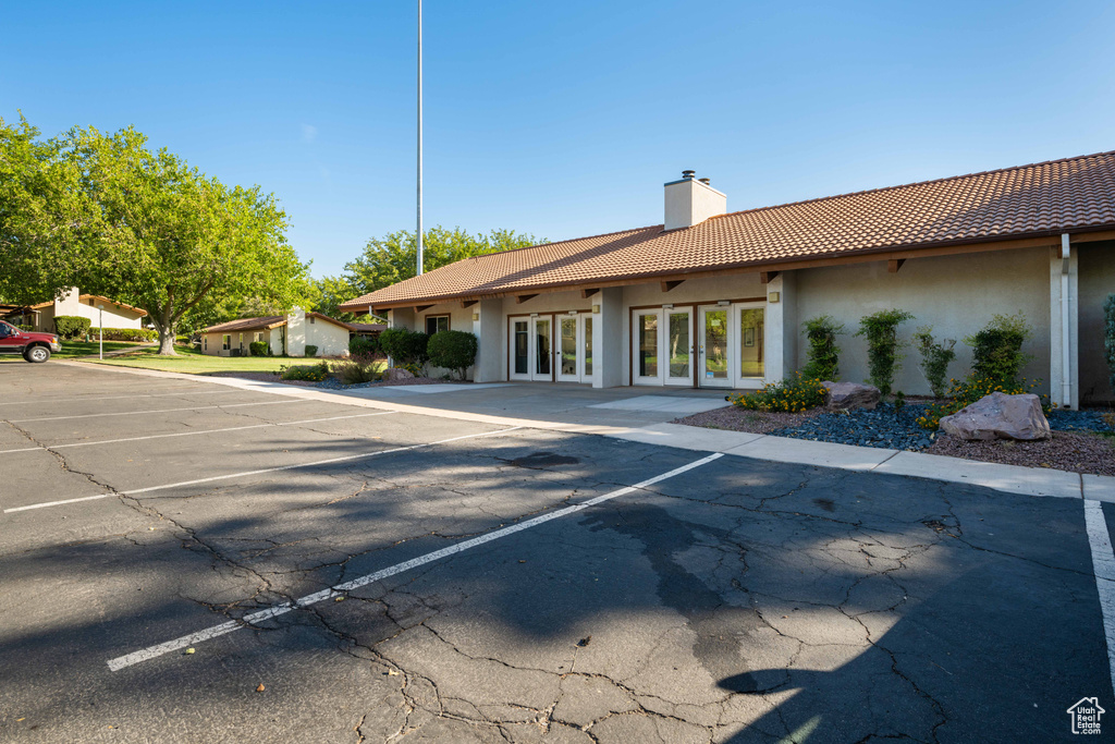 View of building exterior featuring uncovered parking