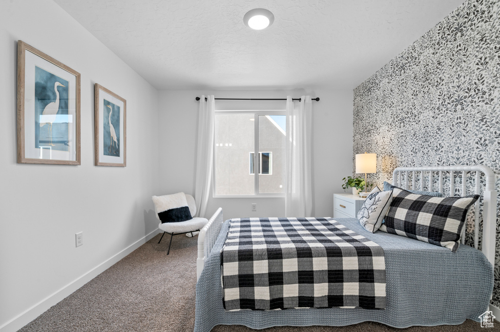 Bedroom featuring carpet floors and baseboards