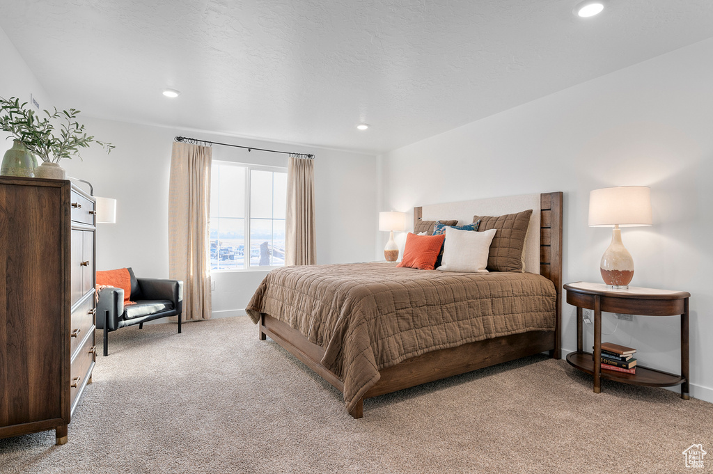 Bedroom with light colored carpet, recessed lighting, and baseboards