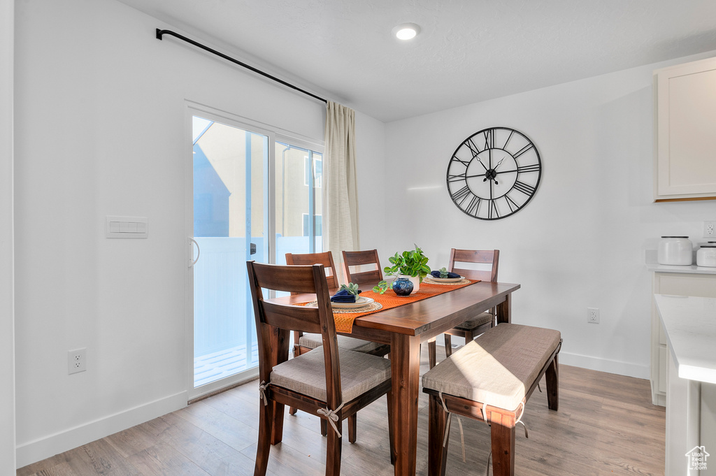 Dining room with recessed lighting, baseboards, and light wood-type flooring